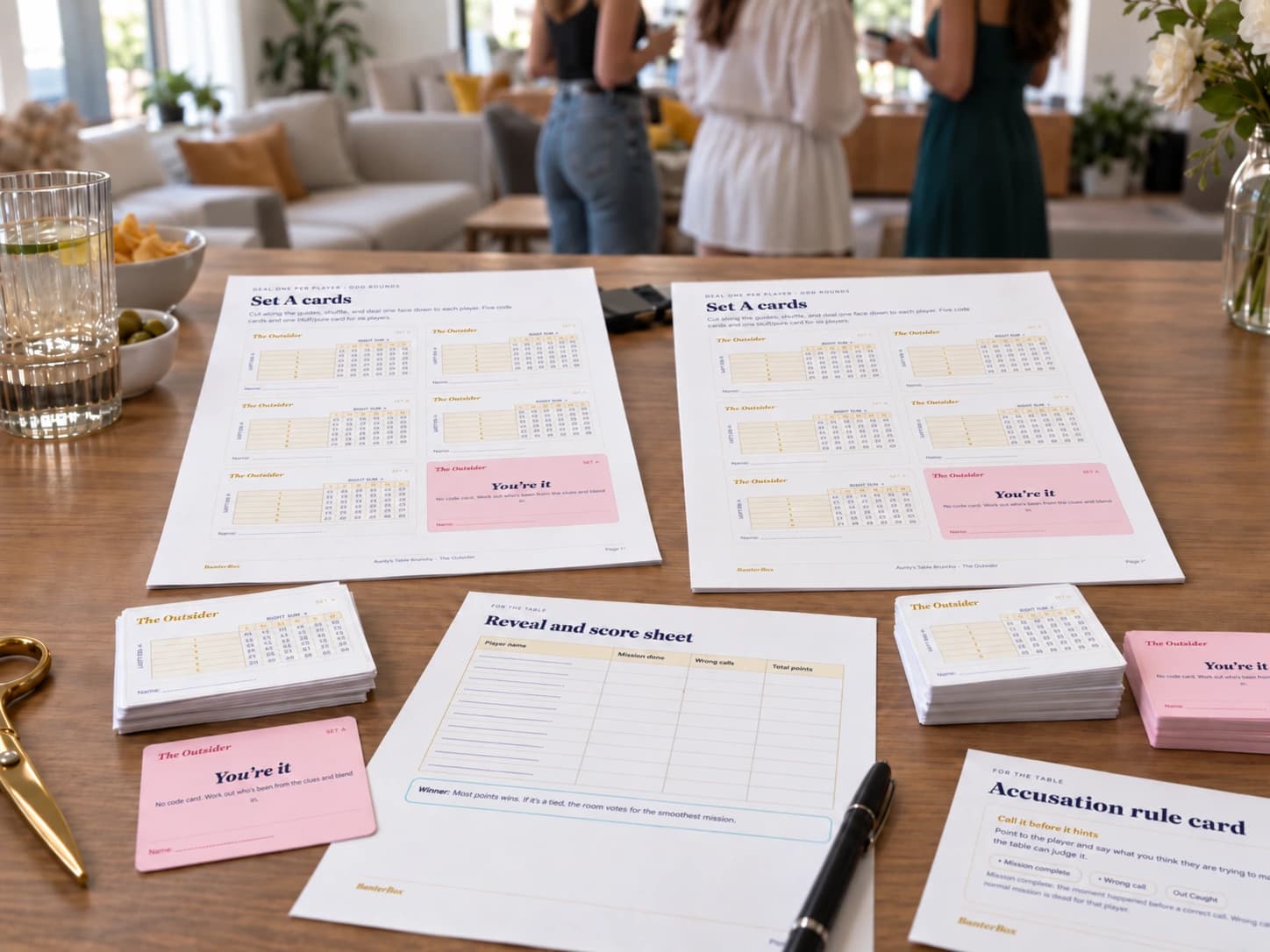 BanterBox cards printed on heavier matte paper beside normal write-on game sheets